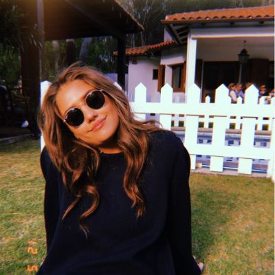 Clara Wilsey sitting and enjoying the sun in a back yard.